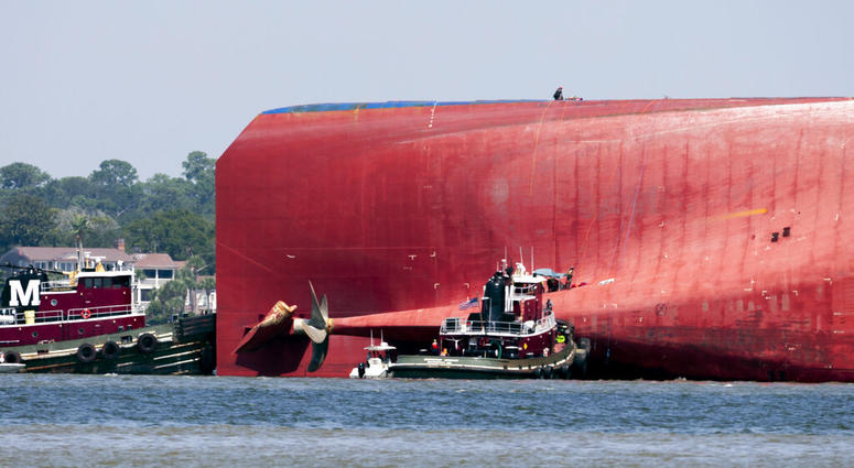 Rescuers work near the stern of the vessel Golden Ray as it lays on its side near the Moran tug boat Dorothy Moran, Monday, Sept. 9, 2019, in Jekyll Island, Ga. AP DO NOT USE