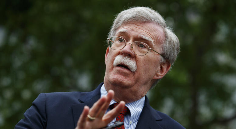 FILE - In this May 1, 2019 file photo, National security adviser John Bolton talks to reporters outside the White House in Washington. Trump says he fired national security adviser John Bolton, says they 'disagreed strongly' on many issues.