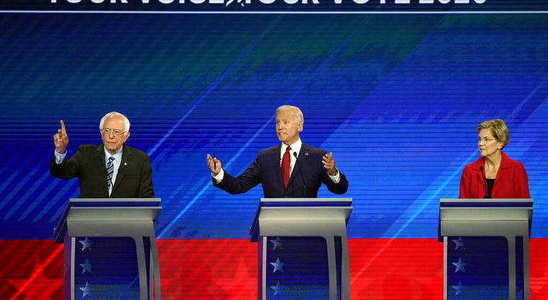 Sen. Elizabeth Warren, D-Mass., right, listens as Sen. Bernie Sanders, I-Vt., left, and former Vice President Joe Biden, right, speak Thursday, Sept. 12, 2019, during a Democratic presidential primary debate hosted by ABC at Texas Southern University