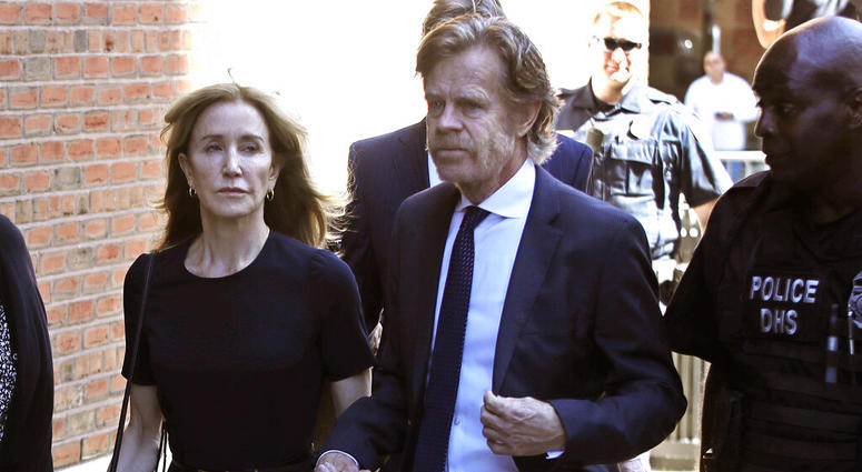 Felicity Huffman arrives at federal court with her husband William H. Macy for sentencing in a nationwide college admissions bribery scandal, Friday, Sept. 13, 2019, in Boston.