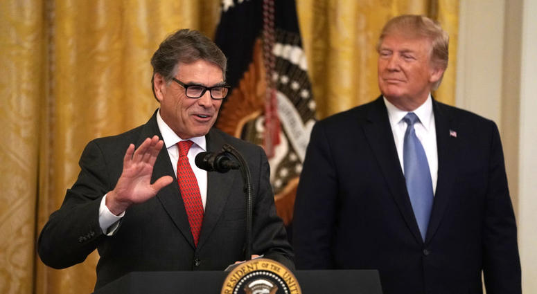 JULY 08: U.S. Secretary of Energy Rick Perry (L) speaks as President Donald Trump (R) looks on during an East Room event on the environment July 7, 2019 at the White House