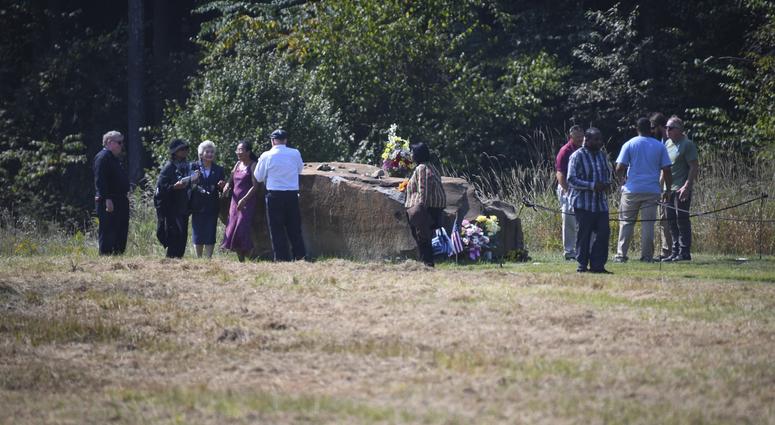 Families gather near the boulder marking the impact area of Flight 93 following the 18th anniversary ceremony of the hijacked Flight 93