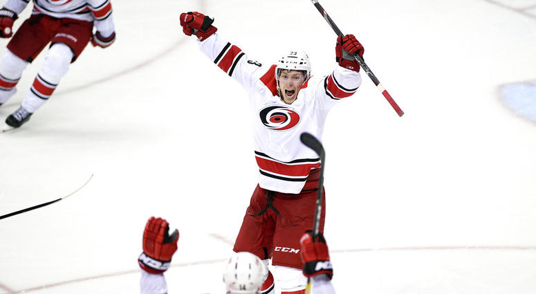 Carolina Hurricanes left wing Brock McGinn (23) celebrates his game-winning goal with Justin Williams (14) in double overtime of Game 7 of an NHL hockey first-round playoff series against the Washington Capitals, Wednesday, April 24, 2019, in Washington. AP DO NOT USE