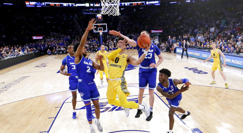 Marquette guard Markus Howard (0) goes up for a shot against Seton Hall players Marquette guard Markus Howard (0) goes up for a shot against Seton Hall players