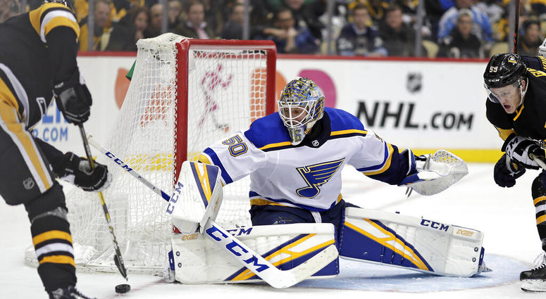 St. Louis Blues goaltender Jordan Binnington (50) blocks a shot by Pittsburgh Penguins' Evgeni Malkin, left, during the second period of an NHL hockey game in Pittsburgh, Saturday, March 16, 2019 St. Louis Blues goaltender Jordan Binnington (50) blocks a shot by Pittsburgh Penguins' Evgeni Malkin, left, during the second period of an NHL hockey game in Pittsburgh, Saturday, March 16, 2019