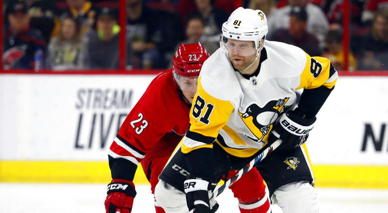Pittsburgh Penguins' Phil Kessel (81) takes the puck away from Carolina Hurricanes' Brock McGinn (23) during the first period of an NHL hockey game, Tuesday, March 19, 2019, in Raleigh, N.C. Pittsburgh Penguins' Phil Kessel (81) takes the puck away from Carolina Hurricanes' Brock McGinn (23) during the first period of an NHL hockey game, Tuesday, March 19, 2019, in Raleigh, N.C.