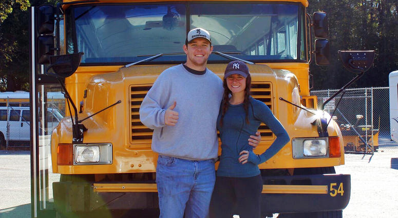 Jack Labosky, left, and Madi Hiatt pose after purchasing a school bus in Lynchburg, Va. Jack Labosky, left, and Madi Hiatt pose after purchasing a school bus in Lynchburg, Va.
