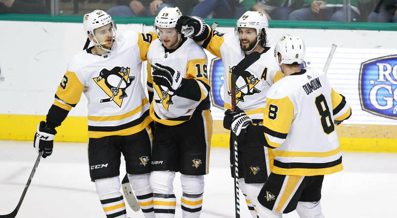 Pittsburgh Penguins center Jared McCann (19) is congratulated for scoring a goal with teammates Teddy Blueger (53), Kris Letang (58), Brian Dumoulin (8) during the second period of an NHL hockey game against the Dallas Stars in Dallas, Saturday, March 23, Pittsburgh Penguins center Jared McCann (19) is congratulated for scoring a goal with teammates Teddy Blueger (53), Kris Letang (58), Brian Dumoulin (8) during the second period of an NHL hockey game against the Dallas Stars in Dallas, Saturday, March 23,