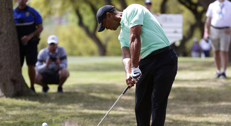 Tiger Woods hits from the rough on the sixth hole during round-robin play at the Dell Match Play Championship golf tournament, Thursday, March 28, 2019, in Austin, Texas. ( Tiger Woods hits from the rough on the sixth hole during round-robin play at the Dell Match Play Championship golf tournament, Thursday, March 28, 2019, in Austin, Texas. (
