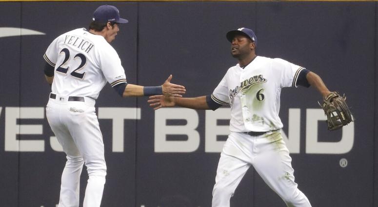 Milwaukee Brewers' Lorenzo Cain is congratulated by Christian Yelich after catching a ball at the wall hit by St. Louis Cardinals' Jose Martinez during the ninth inning of an Opening Day baseball game Thursday, March 28, 2019, in Milwaukee. Milwaukee Brewers' Lorenzo Cain is congratulated by Christian Yelich after catching a ball at the wall hit by St. Louis Cardinals' Jose Martinez during the ninth inning of an Opening Day baseball game Thursday, March 28, 2019, in Milwaukee.