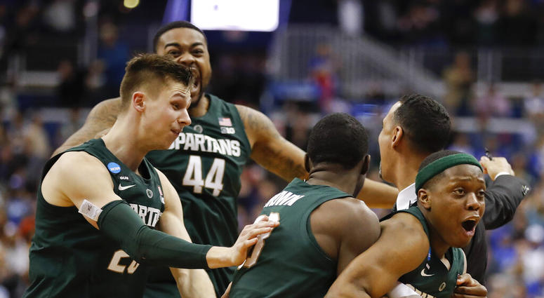 Michigan State guard Cassius Winston, right, celebrates with teammates Matt McQuaid (20), Nick Ward (44) and Gabe Brown (13) after defeating Duke in an NCAA men's East Regional final college basketball game in Washington, Sunday, March 31, 2019. Michigan State guard Cassius Winston, right, celebrates with teammates Matt McQuaid (20), Nick Ward (44) and Gabe Brown (13) after defeating Duke in an NCAA men's East Regional final college basketball game in Washington, Sunday, March 31, 2019.