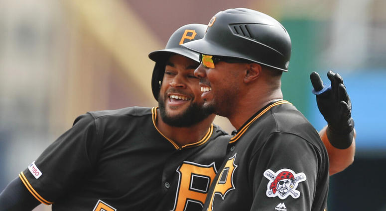 Pittsburgh Pirates Jason Martin, left, puts his arm around first base coach Kimera Bartee after getting his first major league hit off Cincinnati Reds starting pitcher Tanner Roark in the first inning of a baseball game, Saturday, April 6, 2019, in Pittsb Pittsburgh Pirates Jason Martin, left, puts his arm around first base coach Kimera Bartee after getting his first major league hit off Cincinnati Reds starting pitcher Tanner Roark in the first inning of a baseball game, Saturday, April 6, 2019, in Pittsb