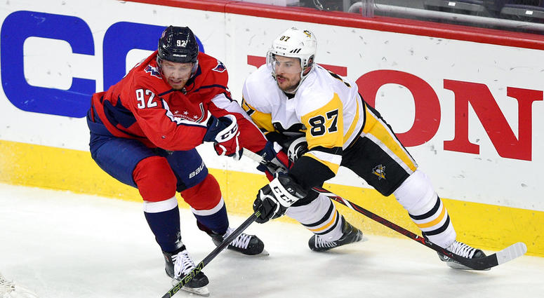 Penguins Sidney Crosby skates with the puck against Washington Capitals center Evgeny Kuznetsov Sidney Crosby