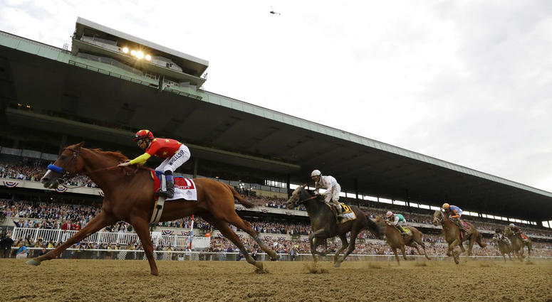 Owners Kenny Trout, right, and Teo Ah Khing hold the August Belmont trophy after their horse Justify won the Triple Crown at the 150th running of the Belmont Stakes horse race DO NOT USE