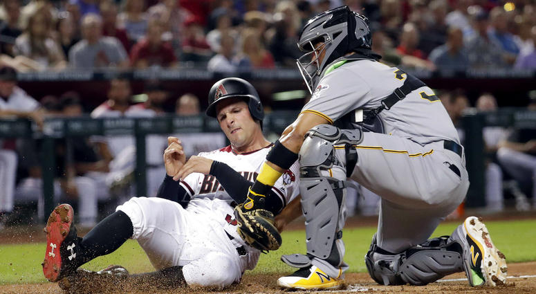 Arizona Diamondbacks' John Ryan Murphy is tagged out by Pittsburgh Pirates catcher Elias Diaz while trying to score on a base hit by Chris Owings during the second inning DO NOT USE