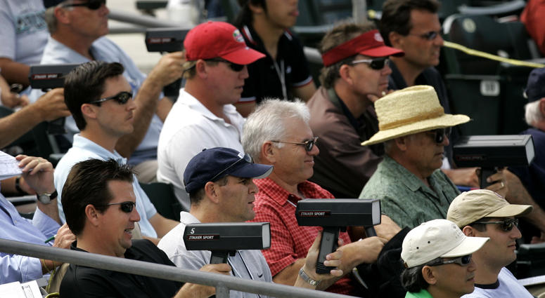 n this March 20, 2007, file photo, baseball scouts use radar guns to read the speed of a pitch during a spring training baseball game between the Florida Marlins and the Washington Nationals in Jupiter, Fla. DO NOT USE