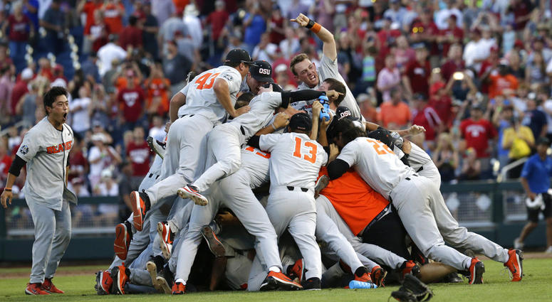 Oregon State players celebrate after they beat Arkansas 5-0 in Game 3 to win the NCAA College World Series baseball finals, DO NOT USE