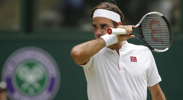 Roger Federer of Switzerland wipes his face during his men's singles match against France's Adrian Mannarino, DO NOT USE