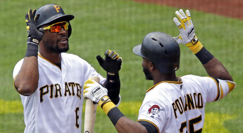 Pittsburgh Pirates' Starling Marte, left, is greeted by Gregory Polanco (25) as he returns to the dugout after hitting a two-run home run DO NOT USE