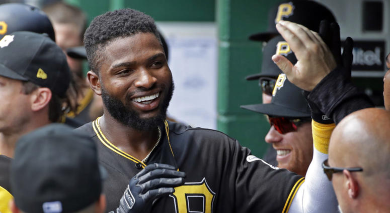 Pittsburgh Pirates' Gregory Polanco celebrates in the dugout after hitting a solo home run off Milwaukee Brewers starting pitcher Chase Anderson DO NOT USE