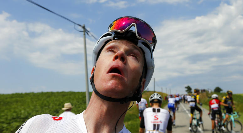 Britain's Chris Froome grimaces after being treated for tear gas or pepper spray sprayed on the peloton when a farmer's protest interrupted during the sixteenth stage of the Tour de France cycling race DO NOT USE