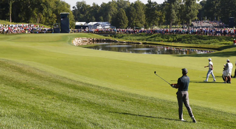 Tiger Woods watches his shot to the 11th green during the first round of the PGA Championship golf tournament at Bellerive Country Club, Thursday, Aug. 9, 2018, in St. Louis. DO NOT USE