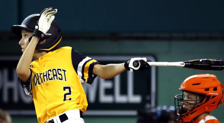 Peachtree City, Georgia's Ben Traxler (2) follows through hon his base hit scoring the winning run against Houston, Texas of an elimination baseball game at the Little League World Series tournament in South Williamsport, Pa., DO NOT USE