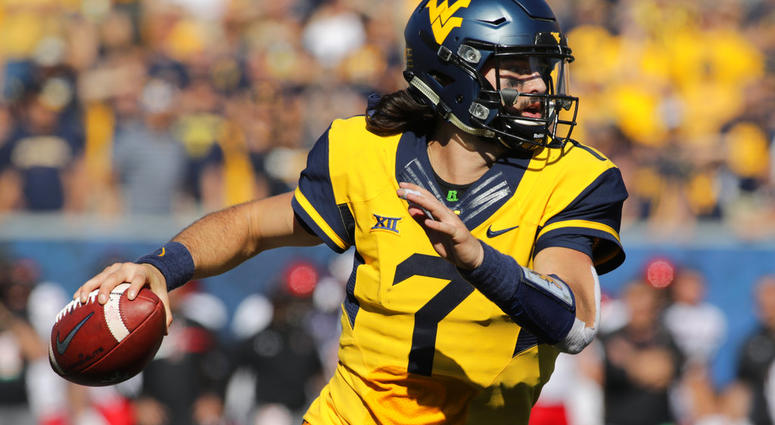 In this Oct. 14, 2017, file photo, West Virginia quarterback Will Grier (7) rolls out during an NCAA college football game, in Morgantown DO NOT USE
