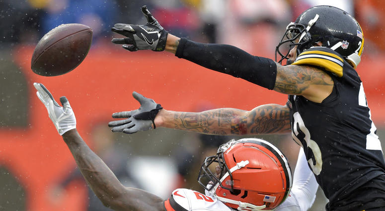 Cleveland Browns wide receiver Josh Gordon, bottom, cannot hold onto the ball under pressure from Pittsburgh Steelers defensive back Joe Haden, top, during the second half of an NFL football game, Sunday, Sept. 9, 2018, in Cleveland. DO NOT USE
