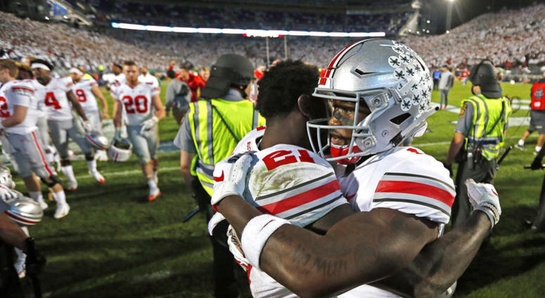 Ohio State's Paris Campbell (21), and Johnnie Dixon (1) embrace after beating Penn State 27-26 in an NCAA college football game in State College, Pa., Saturday, Sept. 29, 2018. DO NOT USE