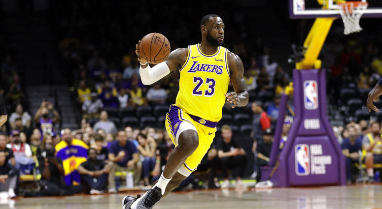 Los Angeles Lakers forward LeBron James dribbles during the first half of an NBA preseason basketball game against the Denver Nuggets, Sunday, Sept. 30, 2018, in San Diego. DO NOT USE