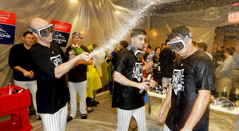The New York Yankees celebrate in the locker room after beating the Oakland Athletics 7-2 in the American League wild-card playoff baseball game, Wednesday, Oct. 3, 2018, in New York. DO NOT USE