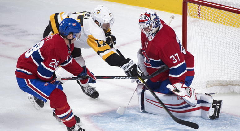 Pittsburgh Penguins' Bryan Rust (17) moves in on Montreal Canadiens goaltender Antti Niemi as Canadiens' Noah Juulsen defends during the third period of an NHL hockey game, Saturday, Oct. 13, 2018 in Montreal. DO NOT USE