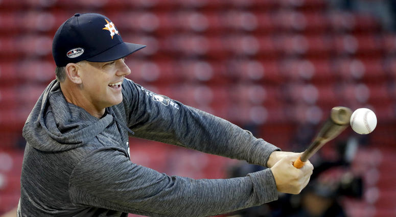 Houston Astros manager AJ Hinch hits during batting practice before Game 2 of a baseball American League Championship Series against the Boston Red Sox on Sunday, Oct. 14, 2018, in Boston. DO NOT USE