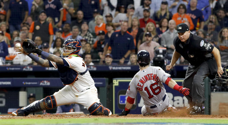 Boston Red Sox's Andrew Benintendi, right, scores past Houston Astros catcher Martin Maldonado on a single by Xander Bogaerts during the fifth inning in Game 4 of a baseball American League Championship Series on Wednesday, Oct. 17, 2018, in Houston. DO NOT USE