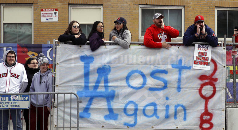 Boston Red Sox fans line the parade route, waiting to celebrate the team's World Series championship over the Los Angeles Dodgers, Wednesday, Oct. 31, 2018, in Boston. DO NOT USE