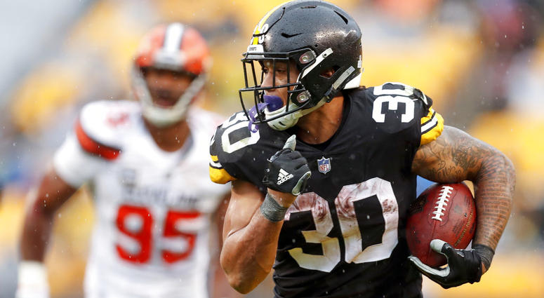 Pittsburgh Steelers running back James Conner (30) breaks away from Cleveland Browns defensive end Myles Garrett DO NOT USE