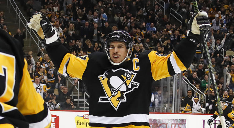 Pittsburgh Penguins' Sidney Crosby (87) celebrates a goal by Dominik Simon with teammates during the second period of an NHL hockey game against the Arizona Coyotes in Pittsburgh, Saturday, Nov. 10, 2018. DO NOT USE