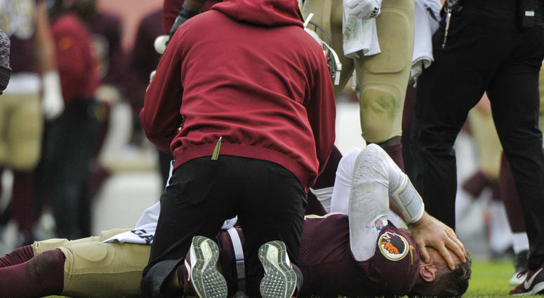 Washington Redskins quarterback Alex Smith, bottom, reacts after an injury during the second half of an NFL football game against the Houston Texans, Sunday, Nov. 18, 2018, in Landover, Md. DO NOT USE