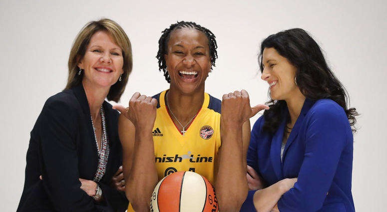 file photo, Indiana Fever's Tamika Catchings jokes with head coach Stephanie White, right, and Kelly Krauskopf, president and general manager, during WNBA basketball media day in Indianapolis. DO NOT USE