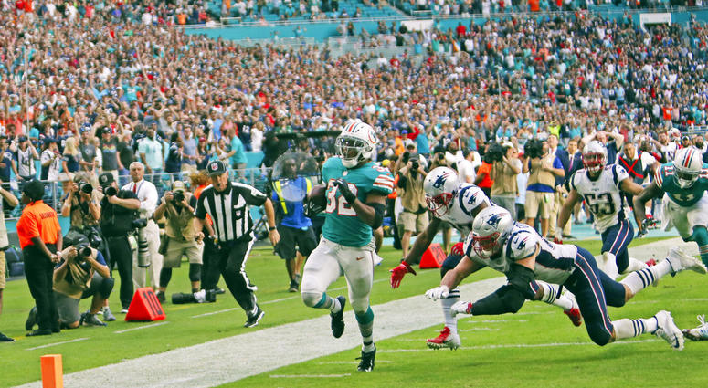 ile photo, Miami Dolphins running back Kenyan Drake (32) runs for a touchdown in the closing seconds of the second half of an NFL football game against the New England Patriots in Miami Gardens, Fla. DO NOT USE
