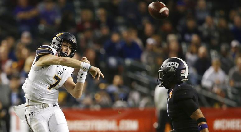 California quarterback Chase Garbers (7) throws a pass over TCU linebacker Arico Evans, right, during the first half of the Cheez-It Bowl NCAA college football game Wednesday, Dec. 26, 2018, in Phoenix. DO NOT USE