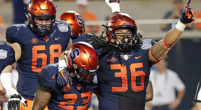 Syracuse fullback Chris Elmore (36) celebrates with running back Abdul Adams (23) after Adams scored a touchdown on a 3-yard run against West Virginia Syracuse fullback Chris Elmore (36) celebrates with running back Abdul Adams (23) after Adams scored a touchdown on a 3-yard run against West Virginia