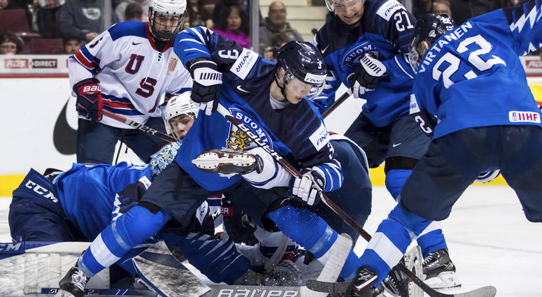 Finland goalie Ukko-Pekka Luukkonen, left, stops United States' Noah Cates Finland goalie Ukko-Pekka Luukkonen, left, stops United States' Noah Cates