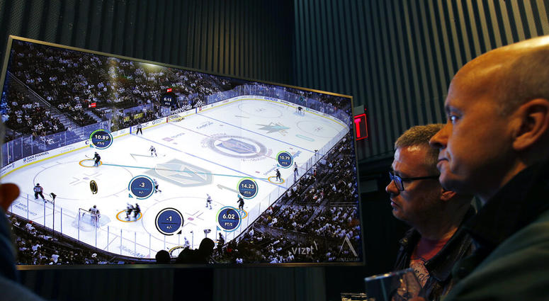 People watch real-time puck and player tracking technology on display during an NHL hockey game between the Vegas Golden Knights and the San Jose Sharks AP DO NOT USE