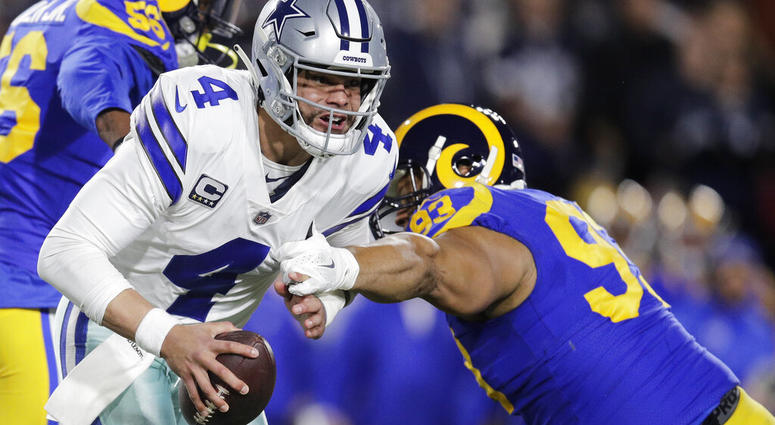 Dallas Cowboys quarterback Dak Prescott breaks away from Los Angeles Rams Dallas Cowboys quarterback Dak Prescott breaks away from Los Angeles Rams