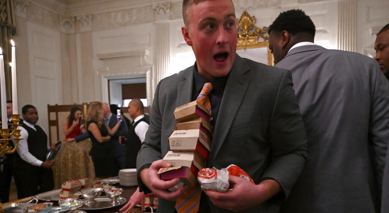 Guests attending a reception for the Clemson Tigers grab fast food sandwiches in the State Dining Room of the White House in Washington, Monday, Jan. 14, 2019. DO NOT USE