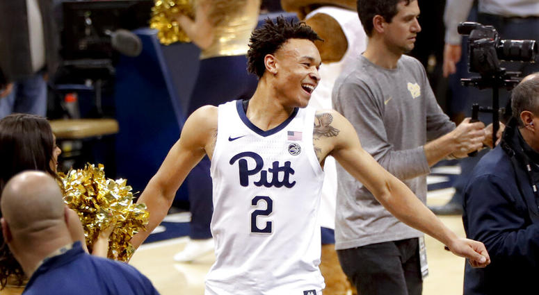 Pittsburgh's Trey McGowens (2) looks back for teammates as he celebrates while leaving the court after defeating number 11 Florida State in an NCAA college basketball game,