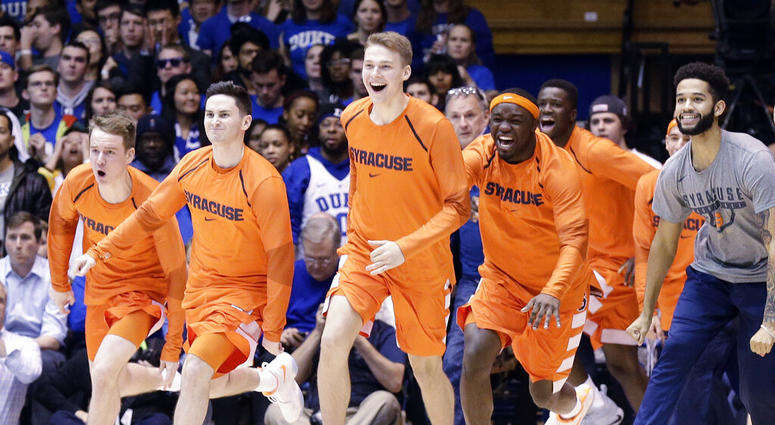 Syracuse players celebrate as time expires during overtime in an NCAA college basketball AP DO NOT USE