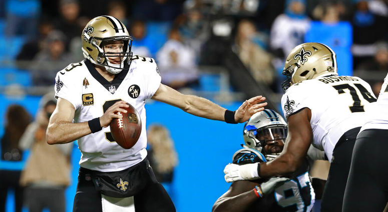 New Orleans Saints' Drew Brees (9) scrambles away from a Carolina Panthers defender during the first half of an NFL football game AP DO NOT USE